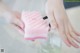 A person using a sponge to clean a bottle of water.