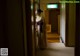 A woman in a kimono standing in a hallway.